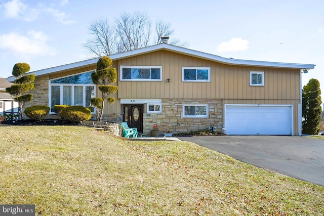 view of front of home with a garage and a front lawn