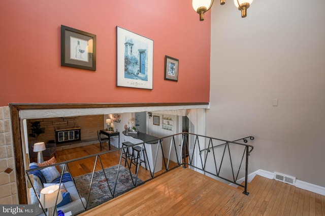 staircase with hardwood / wood-style flooring and a fireplace