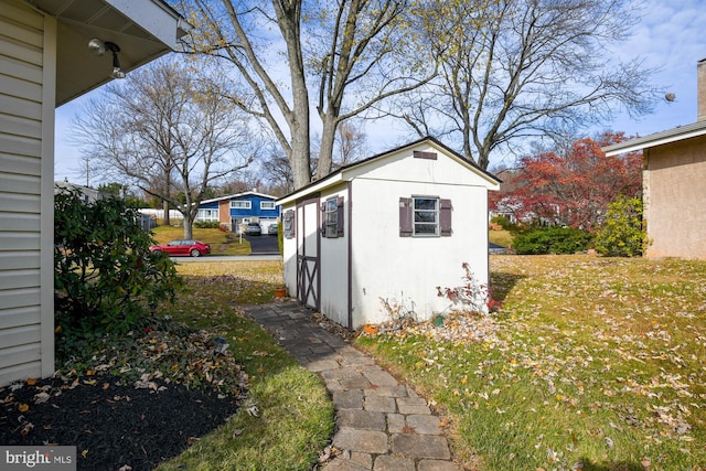 view of outbuilding featuring a yard