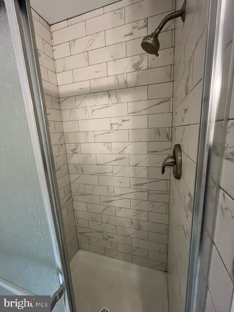 bathroom with a tile shower