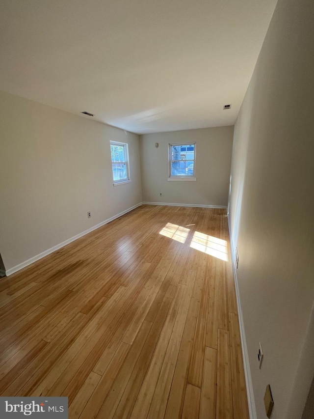 empty room with light hardwood / wood-style floors