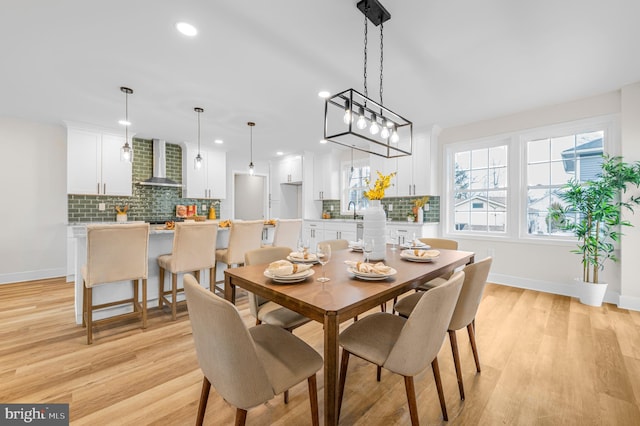 dining room with sink and light wood-type flooring