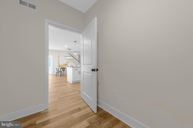 hall with light hardwood / wood-style flooring