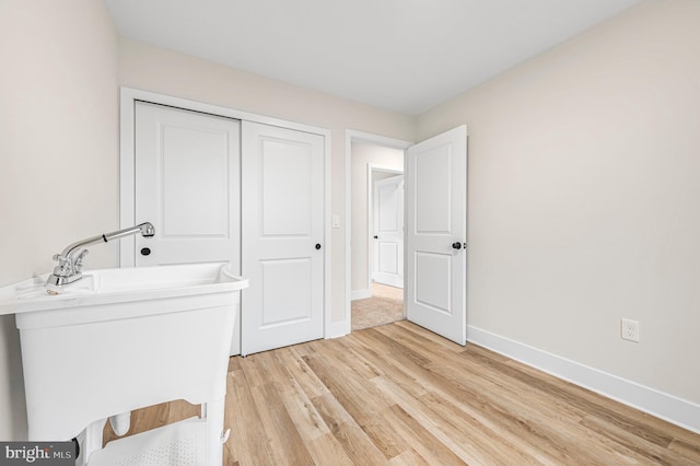 bathroom featuring wood-type flooring and sink