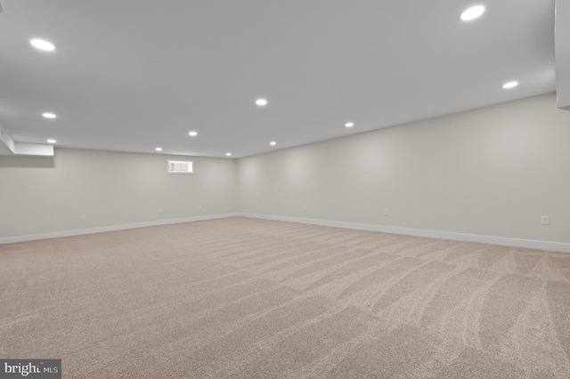 basement featuring light colored carpet