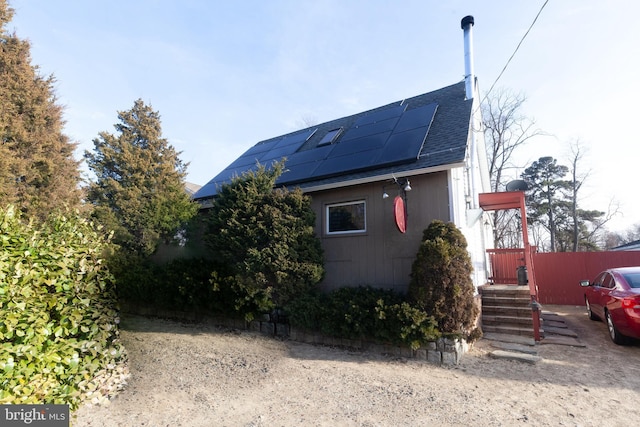 view of side of property with solar panels