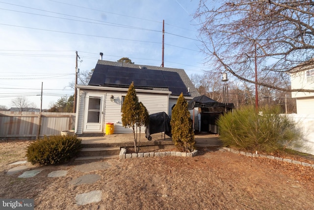 rear view of house with solar panels