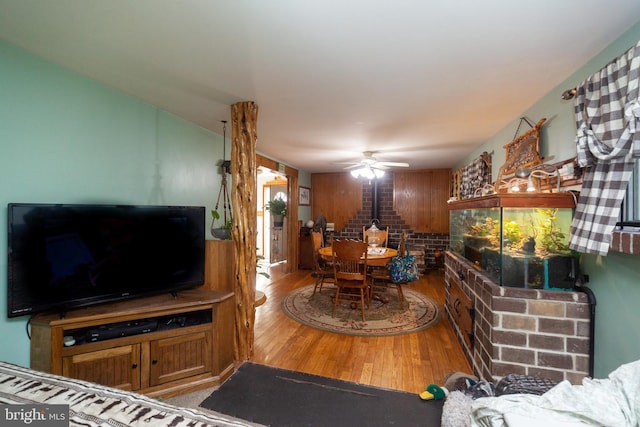 living room with ceiling fan and wood-type flooring