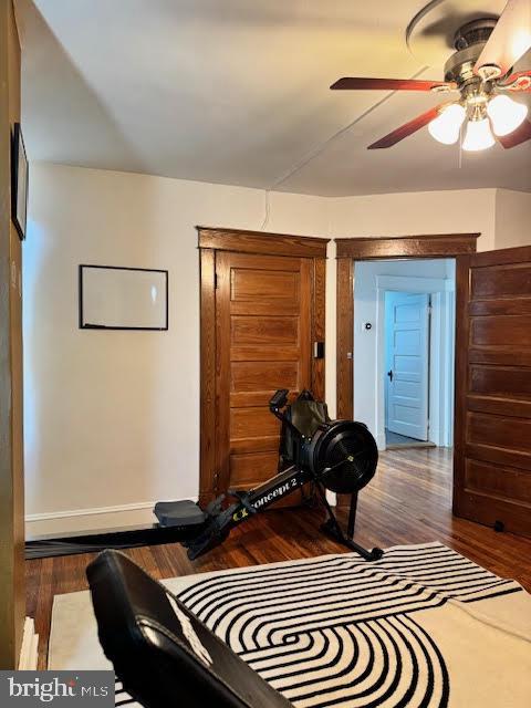 interior space featuring dark wood-type flooring and ceiling fan