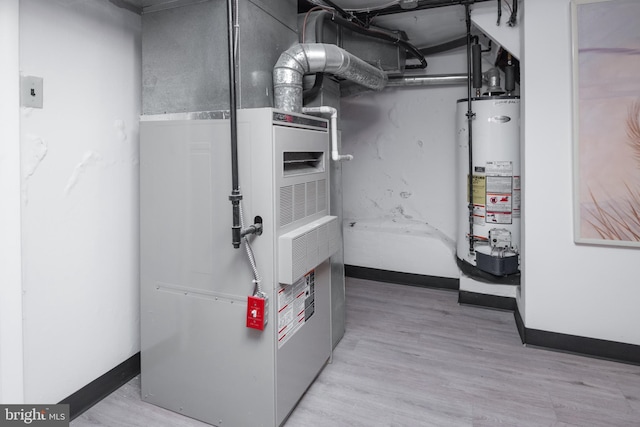 utility room with heating unit and water heater