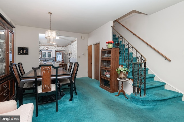 carpeted dining room with a chandelier