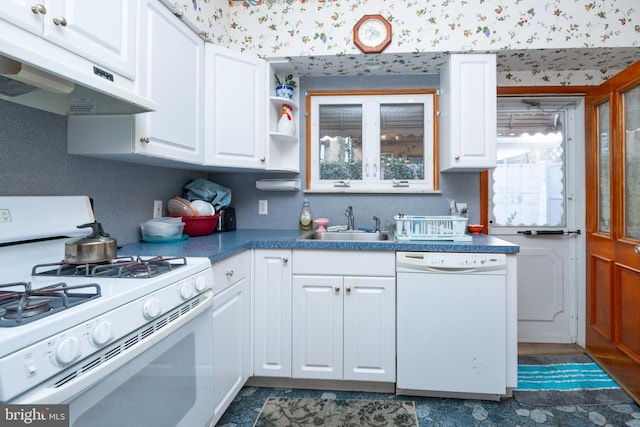 kitchen with sink, white cabinets, and white appliances