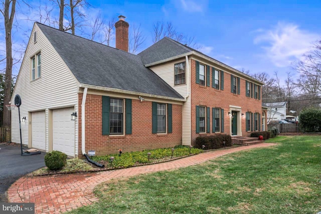 view of side of home with a garage and a lawn