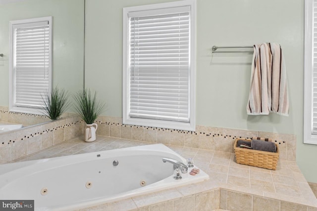 bathroom featuring a wealth of natural light and a relaxing tiled tub