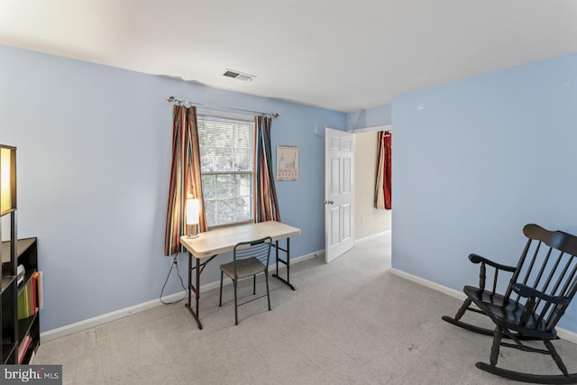 living area featuring light carpet