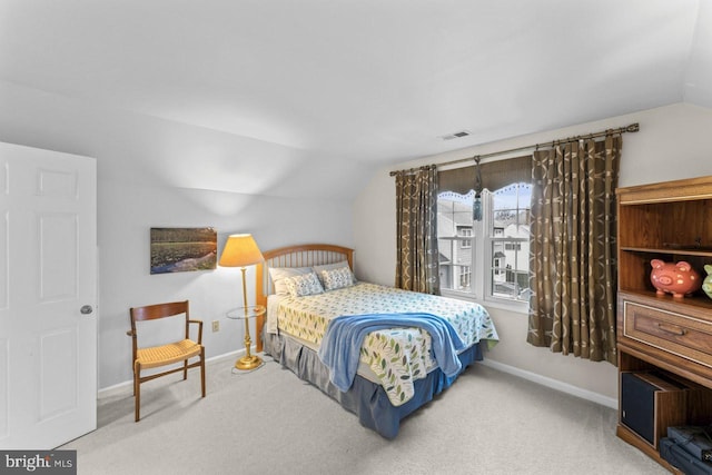 carpeted bedroom featuring lofted ceiling