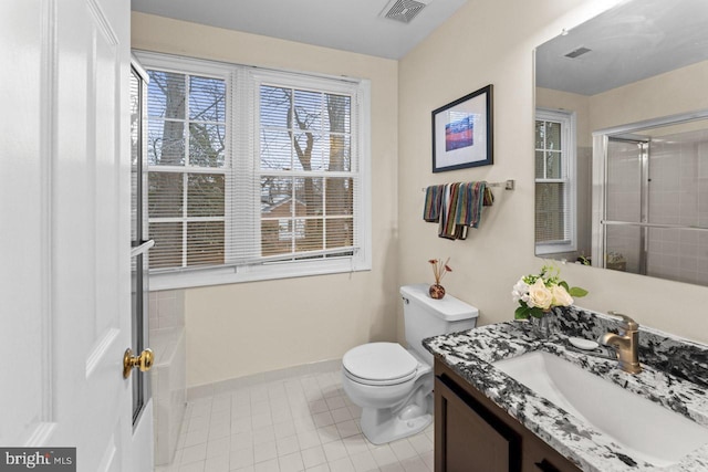 bathroom featuring walk in shower, vanity, toilet, and tile patterned flooring