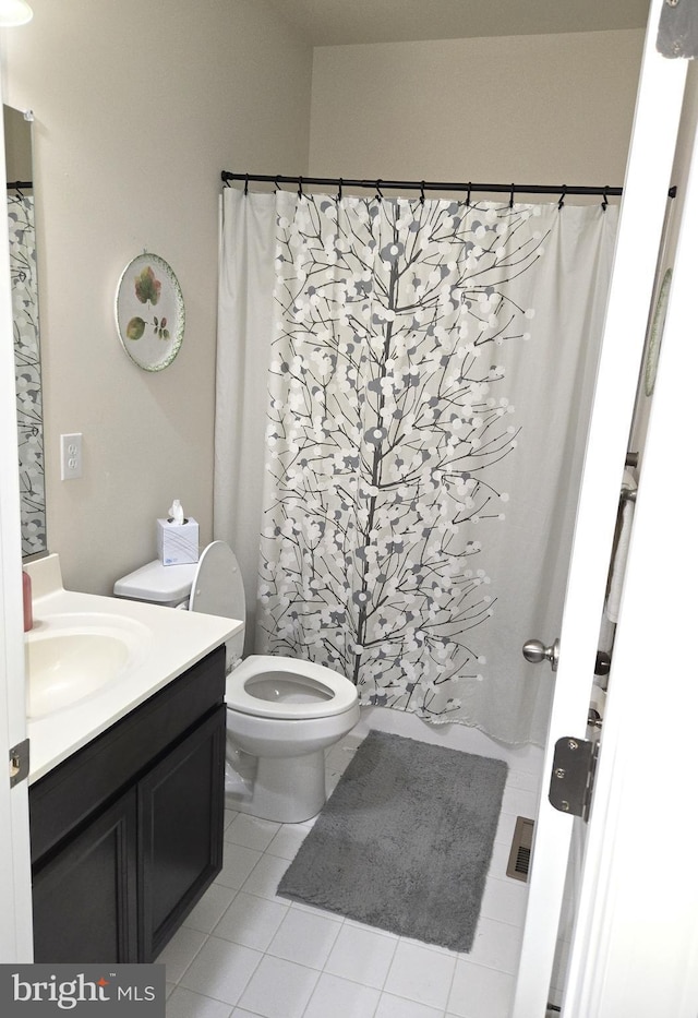 bathroom with vanity, tile patterned floors, and toilet