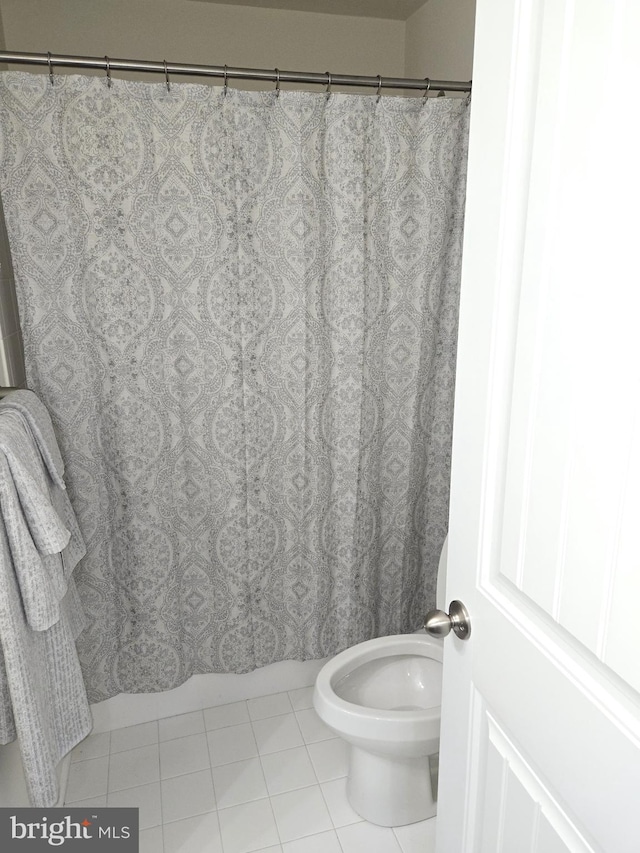 bathroom with tile patterned floors and toilet