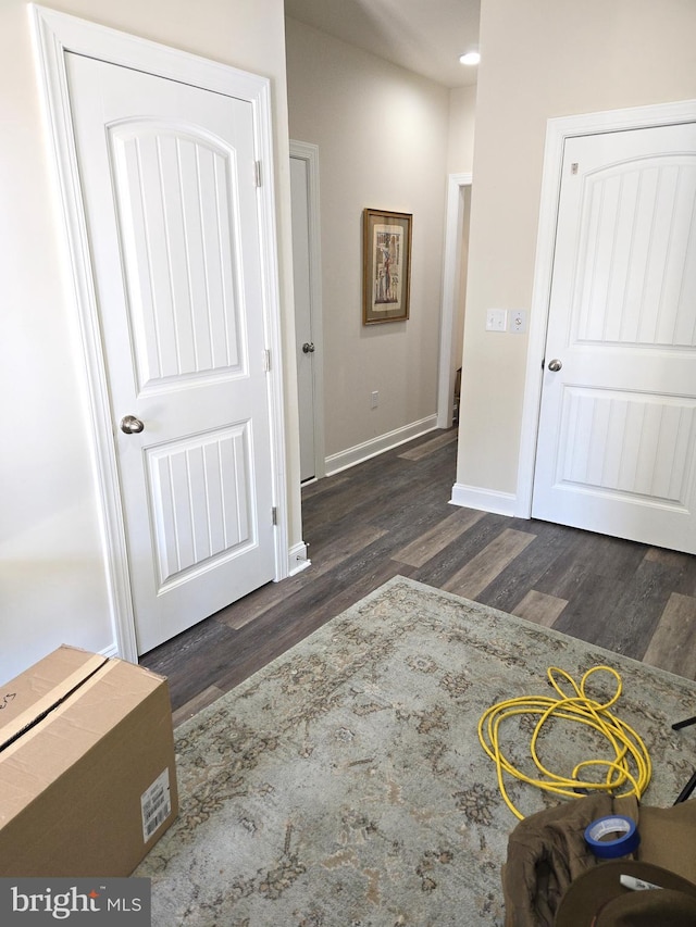 corridor with dark hardwood / wood-style floors