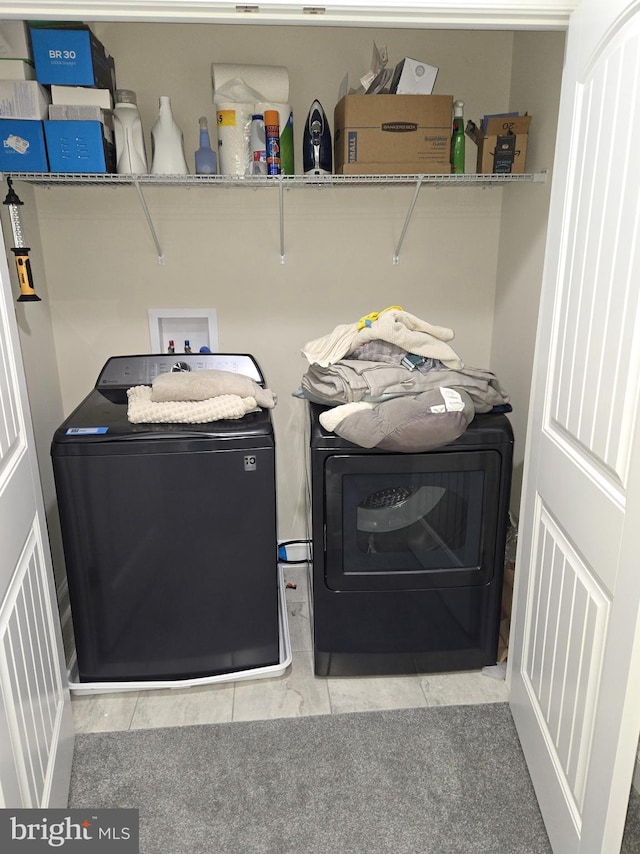 clothes washing area with washer and dryer