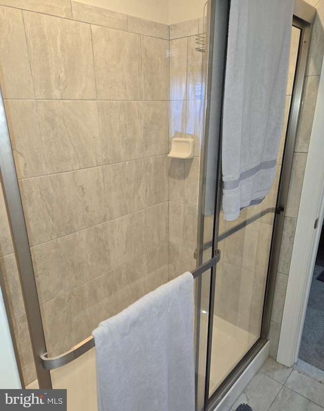 bathroom featuring tile patterned floors and a shower with door