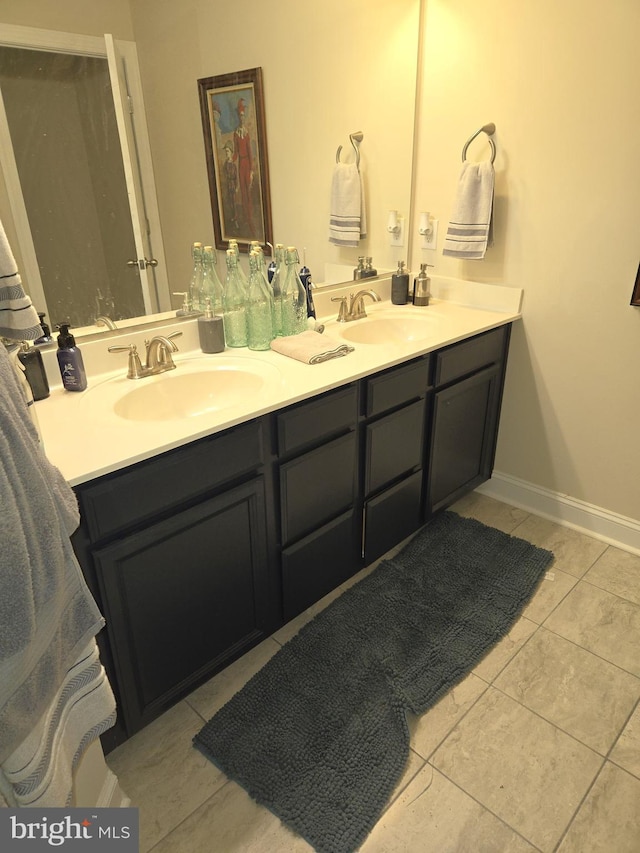 bathroom with tile patterned flooring and vanity