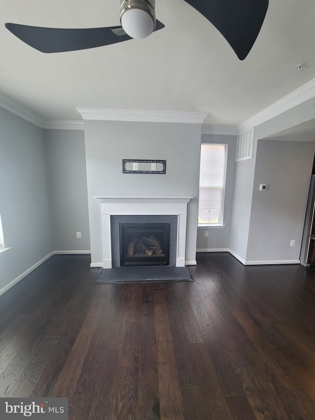 unfurnished living room featuring ornamental molding and dark wood-type flooring