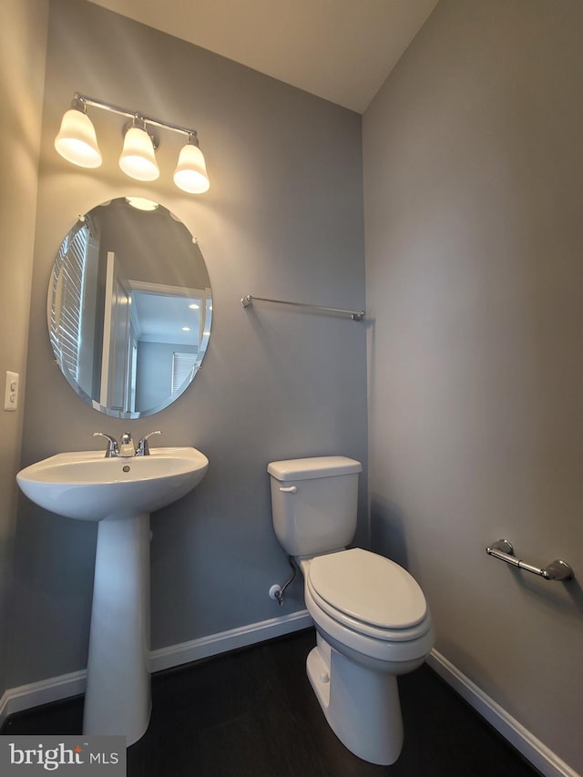 bathroom featuring vaulted ceiling, sink, and toilet