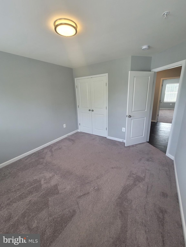 unfurnished bedroom with a closet and carpet