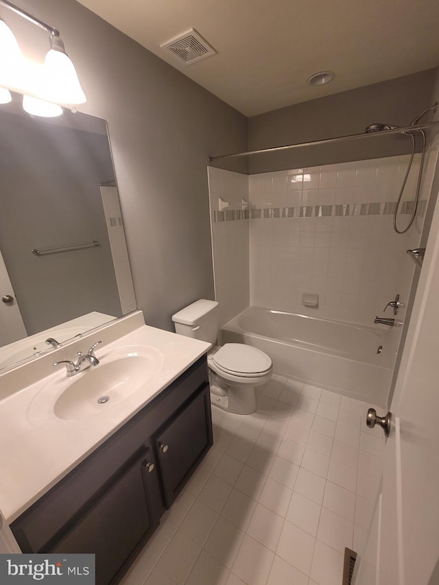 full bathroom with tile patterned floors, vanity, toilet, and tiled shower / bath combo