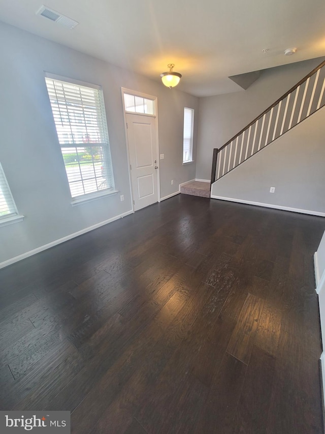 foyer with dark hardwood / wood-style floors and a wealth of natural light