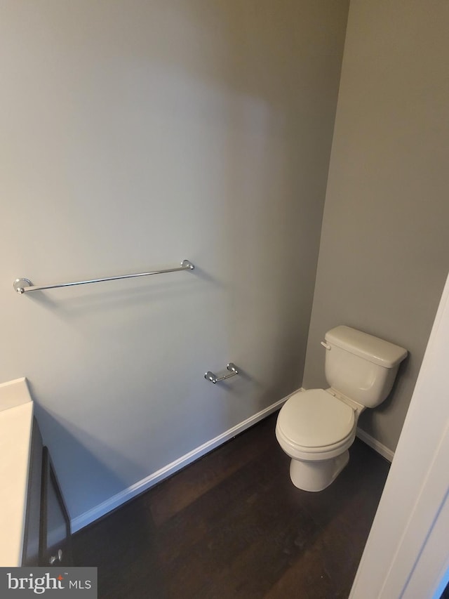 bathroom featuring wood-type flooring and toilet