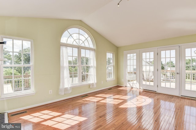 unfurnished sunroom with vaulted ceiling