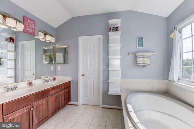 bathroom with tile patterned flooring, vanity, lofted ceiling, and tiled tub