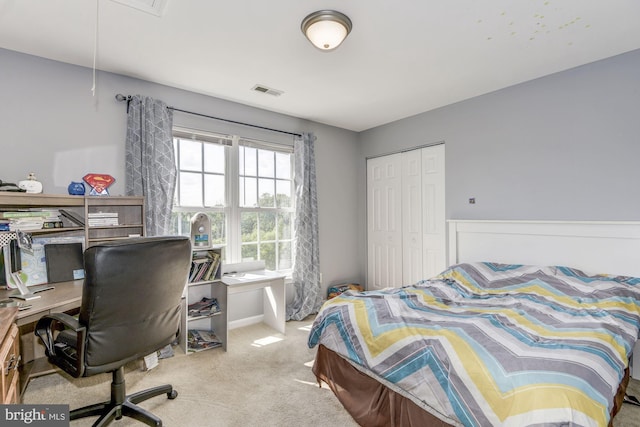 bedroom with light colored carpet and a closet