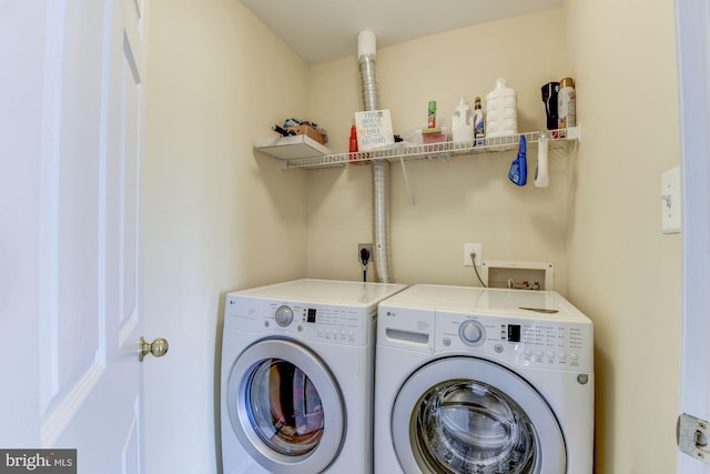 clothes washing area featuring separate washer and dryer