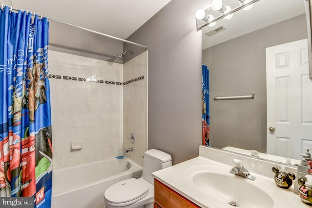 full bathroom with shower / tub combo with curtain, vanity, and toilet