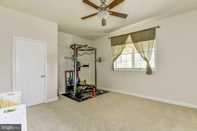 workout area with ceiling fan and carpet