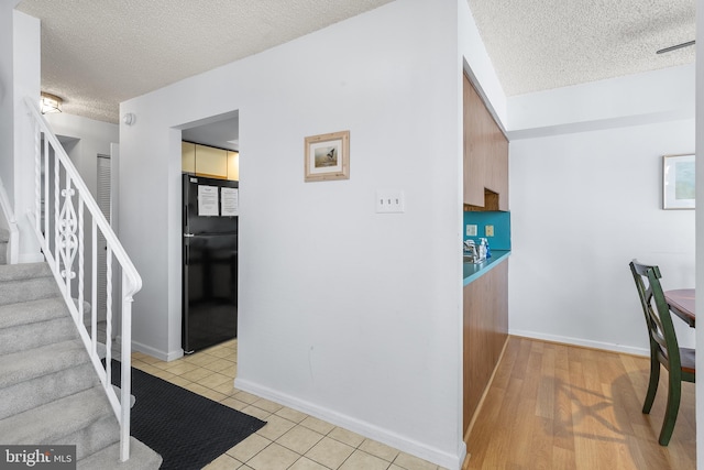 interior space featuring a textured ceiling and light tile patterned floors