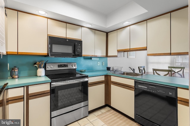 kitchen featuring white cabinetry, sink, light tile patterned floors, and black appliances