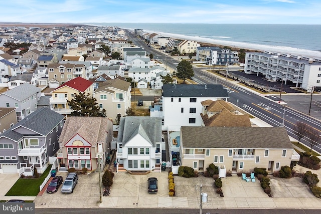 drone / aerial view with a beach view and a water view