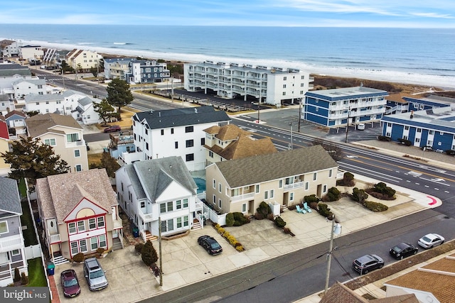 drone / aerial view with a water view and a beach view