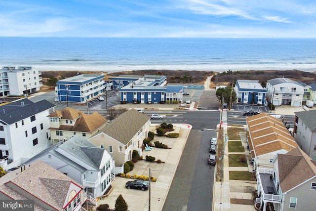 aerial view with a water view and a beach view