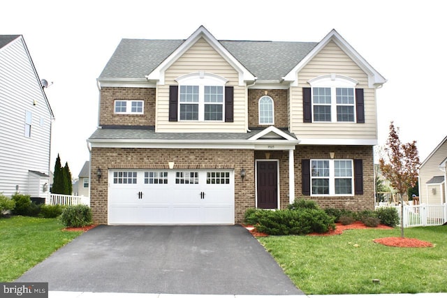 view of front of home with a garage and a front yard