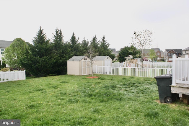 view of yard with a playground and a shed