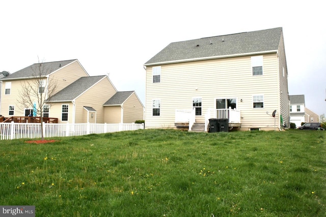 back of property featuring a yard