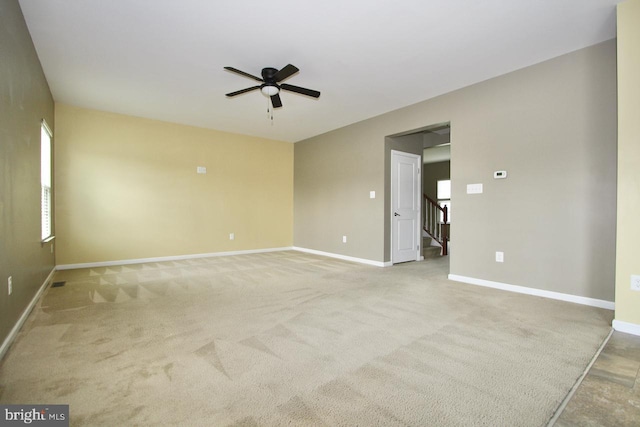 empty room featuring light carpet and ceiling fan