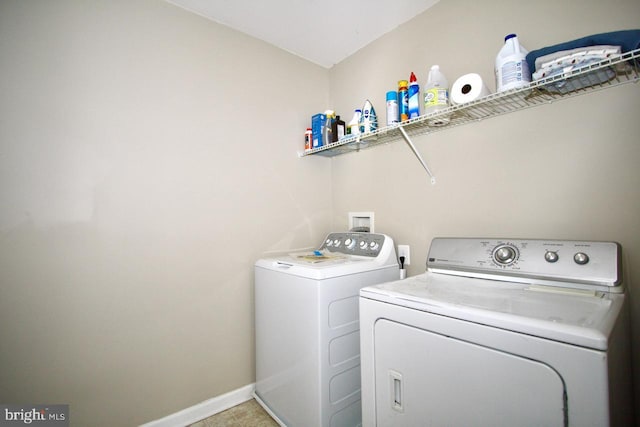 clothes washing area with light tile patterned floors and independent washer and dryer