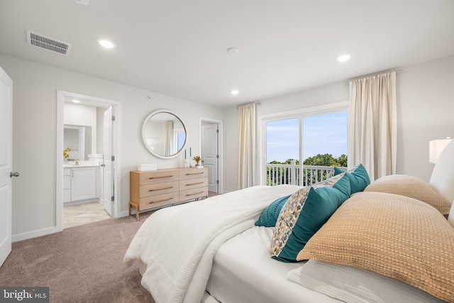 bedroom featuring light carpet, connected bathroom, and access to exterior